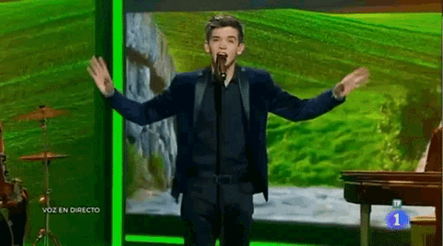 a man singing into a microphone with the number 1 in the corner