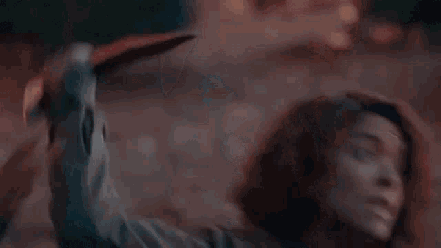 a woman with red hair is screaming with her mouth open in a close up of her face .