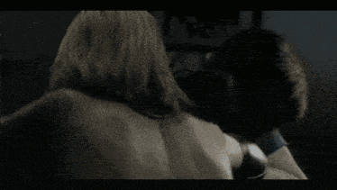 a woman with long hair is being held by a man in a video game