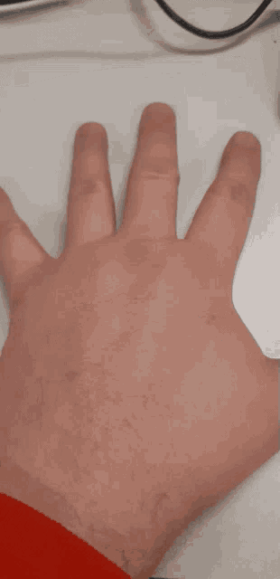 a close up of a person 's hand with their fingers extended
