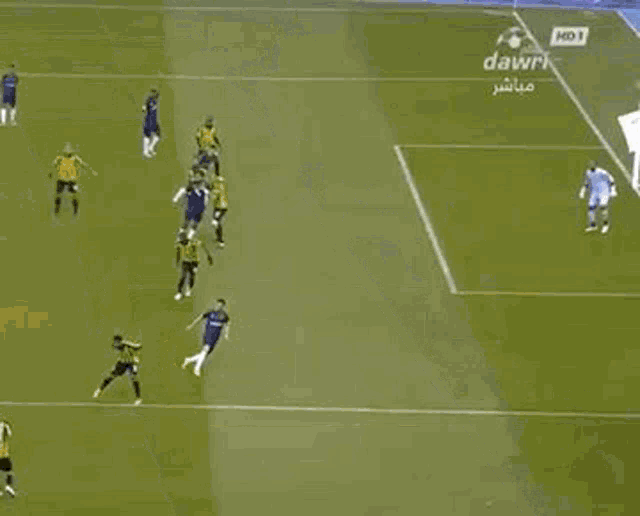 a group of soccer players are playing on a field with ads for dawri in the background