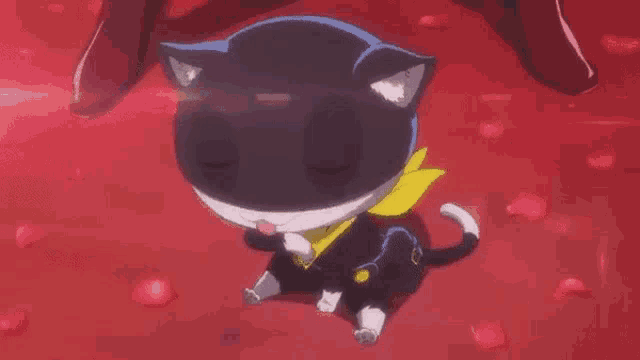 a black and white cat wearing a yellow scarf is sitting on a red floor .