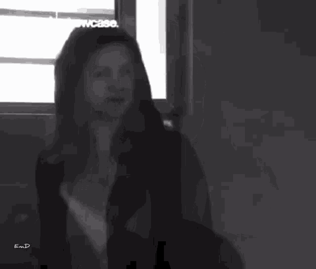 a woman 's face is shown in a black and white photo taken by e.m.d