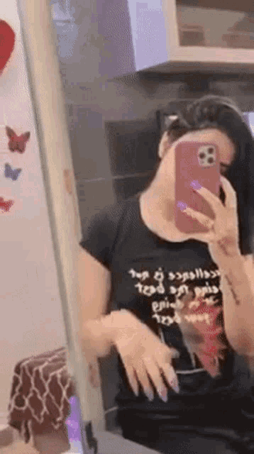 a woman is taking a picture of herself in a mirror