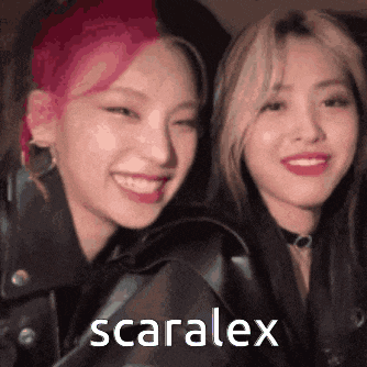 a couple of women standing next to each other and smiling with the word scaralex on the bottom .