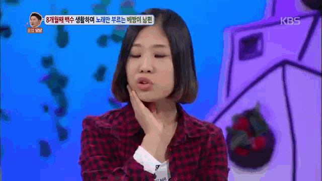 a woman in a plaid jacket is making a funny face on a tv show