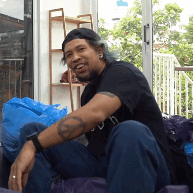 a man with a peace sign on his arm