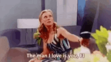 a woman is sitting on a couch and talking to a man .