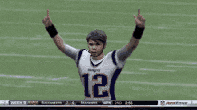 a patriots football player with his arms up in the air