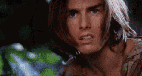 a close up of a man 's face with long hair and a serious look on his face .