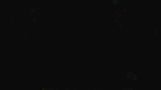 a colorful fireworks display is being displayed in the dark