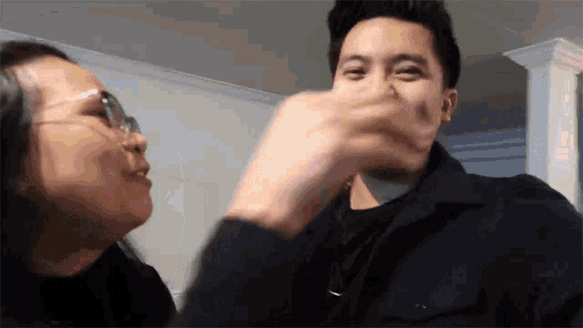 a man and a woman are touching each other 's noses