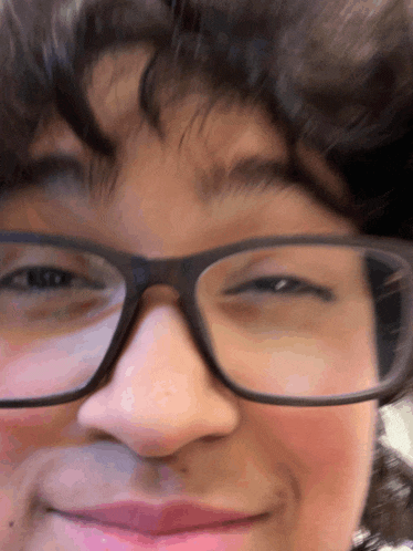 a close up of a person 's face with glasses