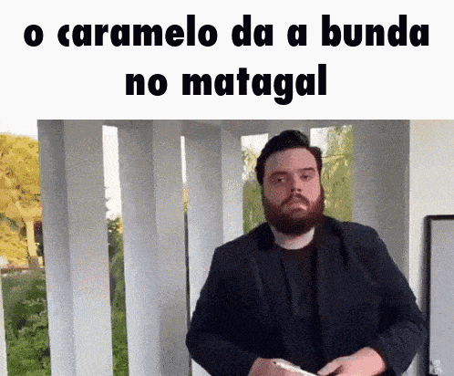 a man with a beard is holding a knife in front of a sign that says " no matagal " on it
