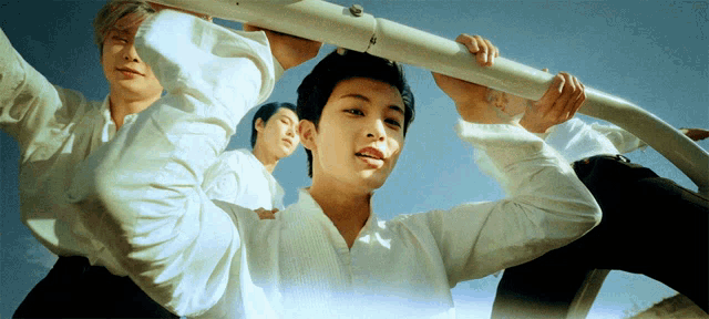 a man in a white shirt is holding a white pole