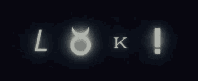 the word loki is glowing in the dark against a black background .
