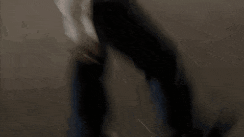 a blurry picture of a woman standing in a park at night