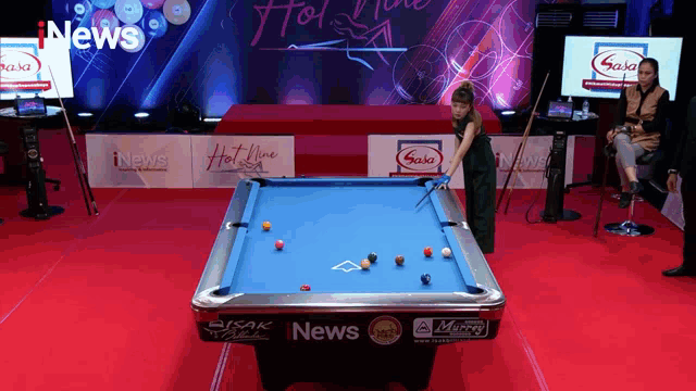 a pool table with a news logo on it