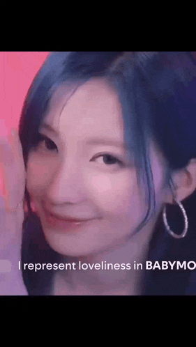 a close up of a woman with blue hair and hoop earrings smiling .