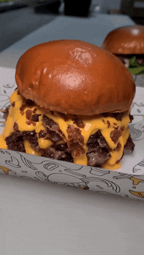 a close up of a hamburger with cheese and bacon on it