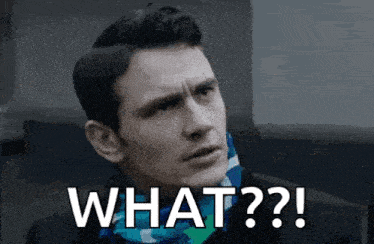 a man in a suit and scarf is making a funny face and saying what ?