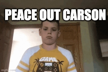 a young boy in a yellow shirt is standing in a hallway with the words `` peace out carson '' written above him .