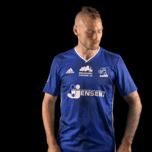 a man wearing a blue adidas shirt with jensen written on it