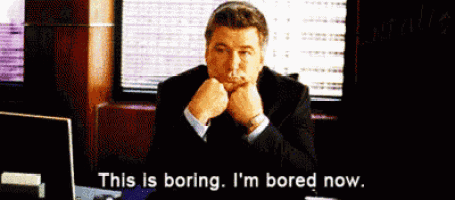 a man in a suit sits at a desk and says " this is boring i 'm bored now " .