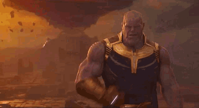 a man with a beard is standing in front of a large fireball