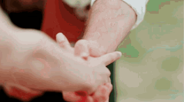 a man and a woman are holding hands in a circle .