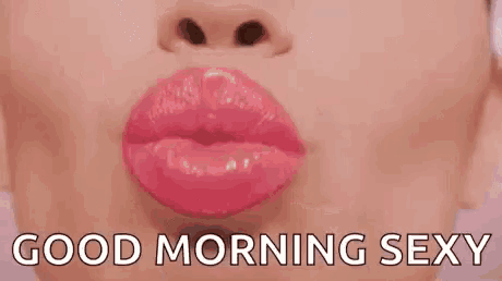 a close up of a woman 's lips with the words `` good morning sexy '' written next to it .