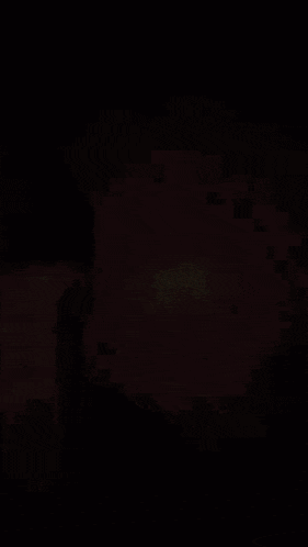 a blurred image of a window with blinds and a cat in the background