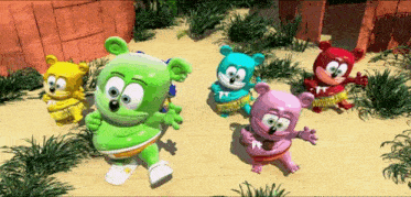 a group of colorful gummy bears are dancing in the sand