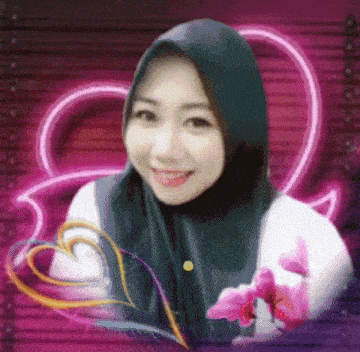 a woman wearing a hijab is smiling in front of a pink heart and flowers