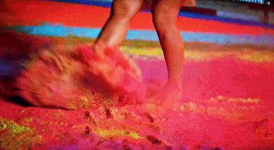 a woman 's legs are shown in a blurry photo with a colorful background