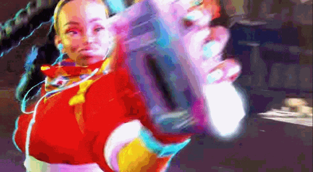 a woman in a red jacket is holding a colorful object in her hand