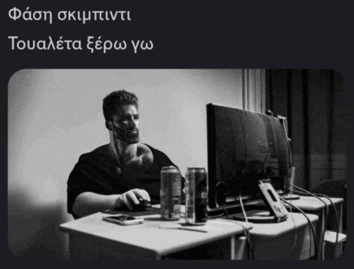 a black and white photo of a man using a computer