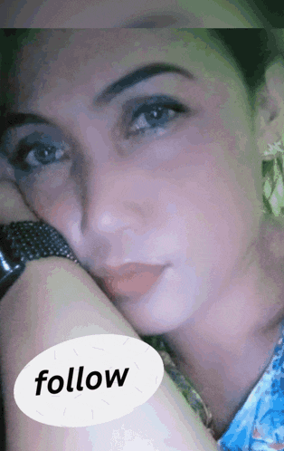 a close up of a woman 's face with a white circle that says follow