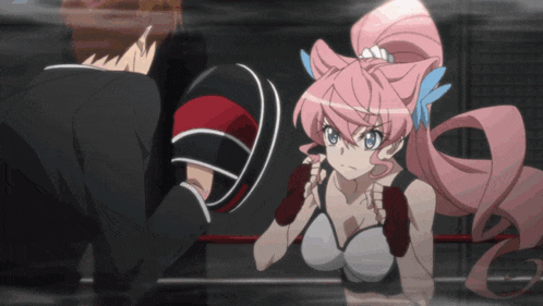 a girl with pink hair is boxing a man in a ring