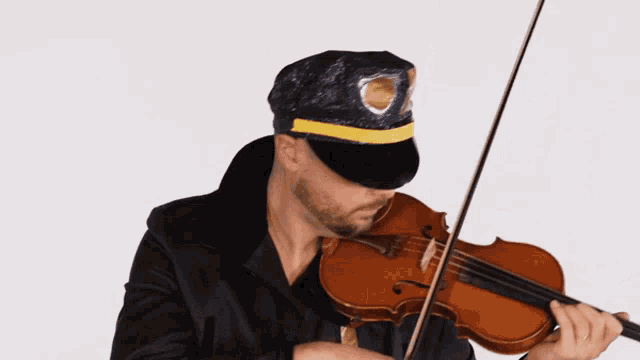 a man in a police hat plays the violin