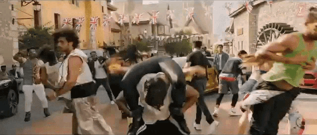 a group of people are dancing on the street in front of a building with british flags