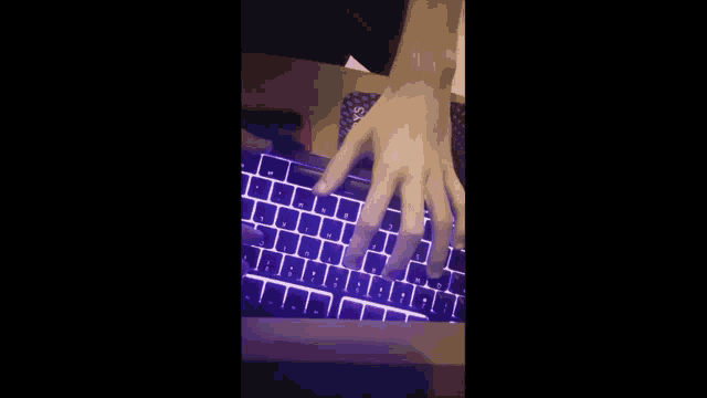 a person 's hand is typing on a keyboard with the letters a b c and d lit up