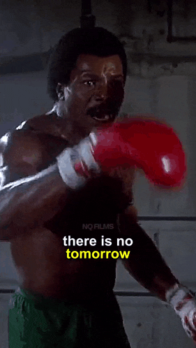 a man wearing red boxing gloves with the words " there is no tomorrow " below him