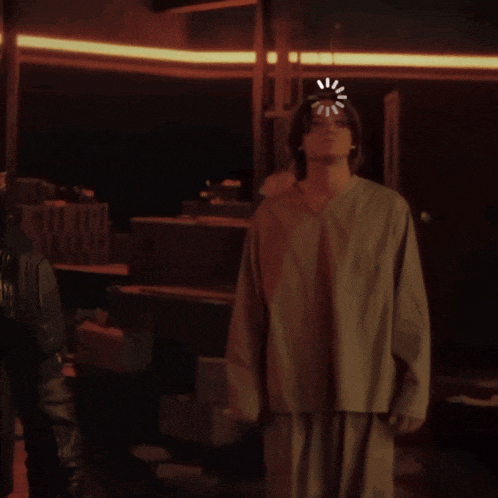 a man stands in a dark room with a loading bar on his head