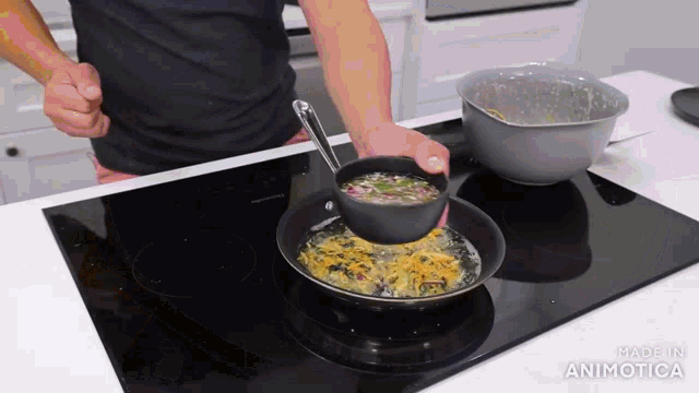 a person is pouring something into a frying pan on a stove with the words made in animatica on the bottom right