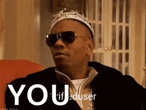a man wearing a crown and sunglasses says " you "