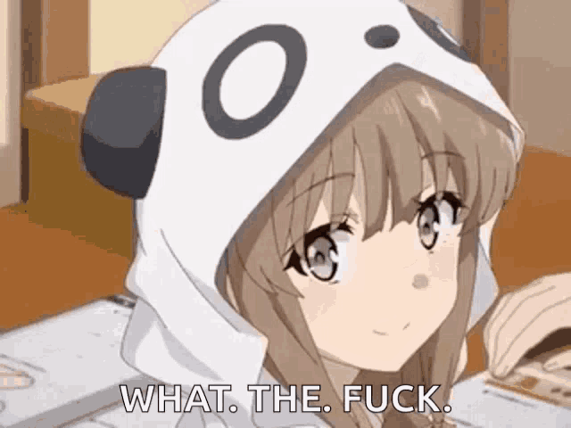 a girl wearing a panda hoodie is sitting at a table and saying `` what the fuck '' .