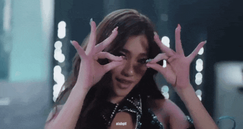 a close up of a woman making a funny face with her hands with the hashtag alabgll