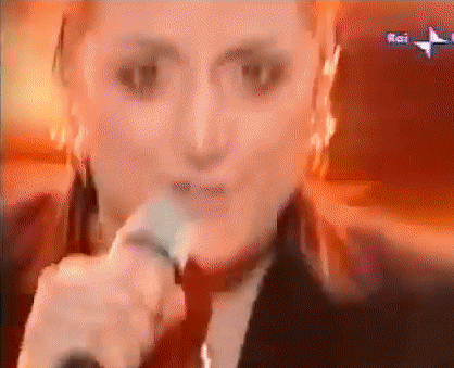 a woman singing into a microphone with the word rai on the bottom