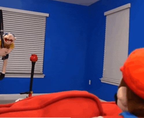 a puppet is hanging from a rope in a room .